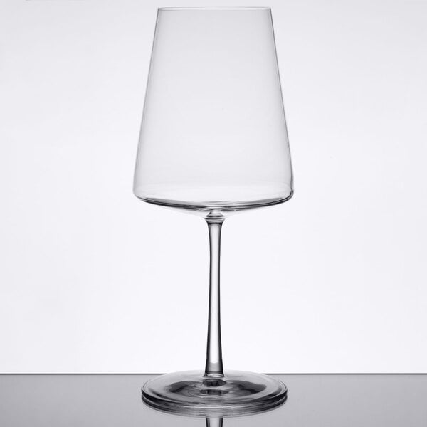 A Stolzle red wine glass on a table.
