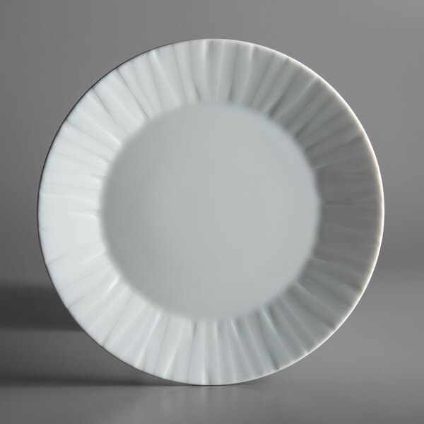 A white Schonwald porcelain plate with wavy edges.