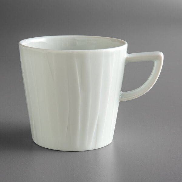 A Schonwald white porcelain mug with a handle.