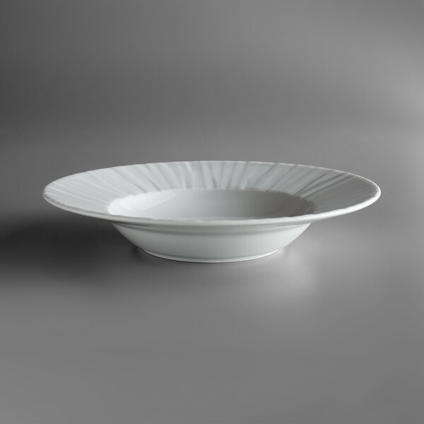 A Schonwald white porcelain bowl with a white rim on a gray surface.