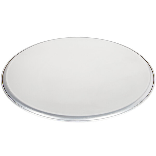 An American Metalcraft aluminum pizza pan with a silver rim and white interior.