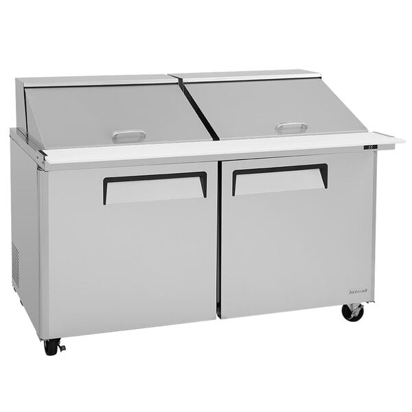A Turbo Air stainless steel refrigerated sandwich prep table with two doors on a counter.