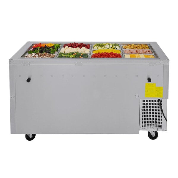 A Turbo Air stainless steel refrigerated buffet table with food on the counter.