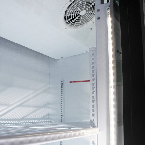 A white Turbo Air refrigerated merchandiser with sliding glass doors and a vent.