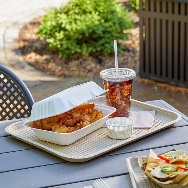 A rectangle EcoChoice paper food tray filled with food on a table.