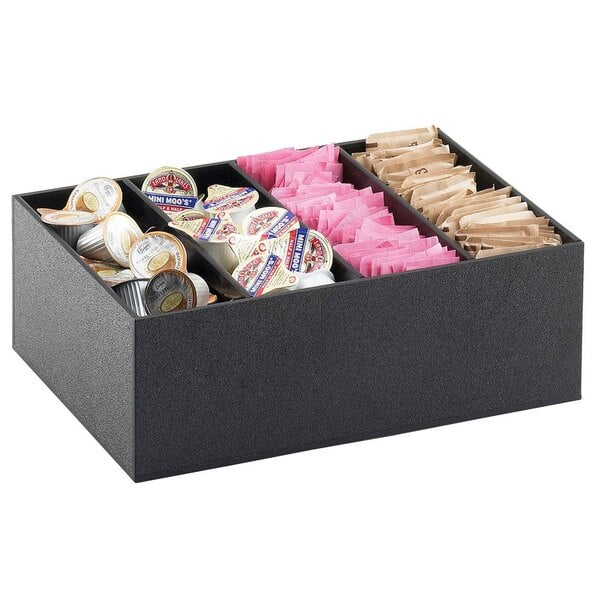 A black Cal-Mil condiment organizer on a counter filled with coffee condiments.