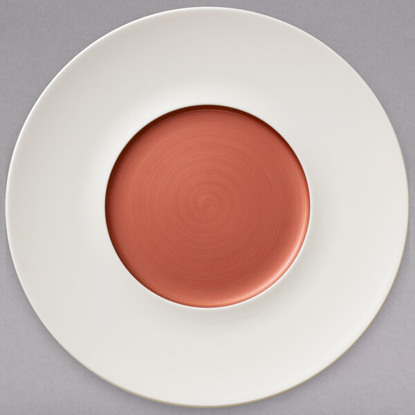 A white Villeroy & Boch porcelain coupe plate with a copper circle in the middle.