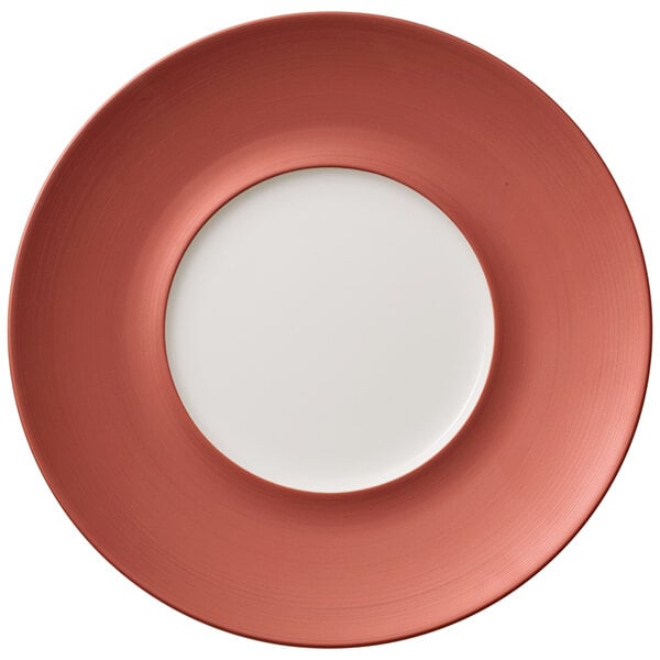 A Villeroy & Boch Copper Glow porcelain coupe plate with a copper rim and white center.