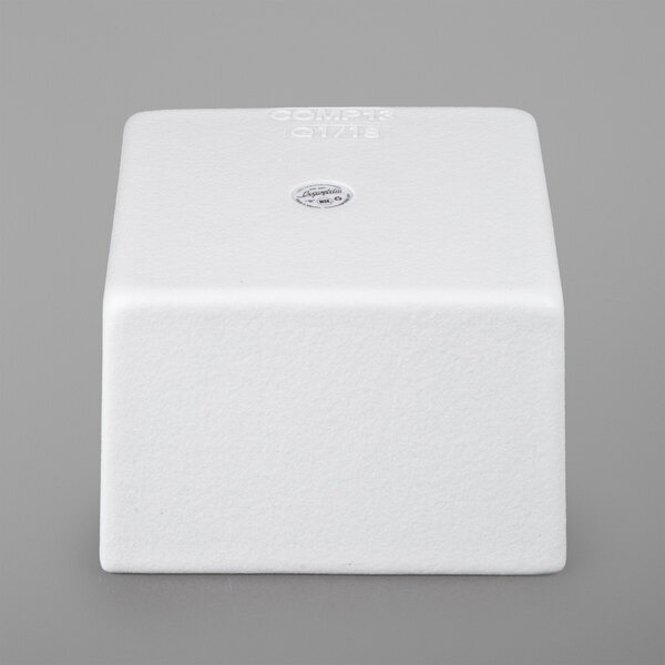 A white square G.E.T. Enterprises Bugambilia dressing insert with a logo sticker on it.