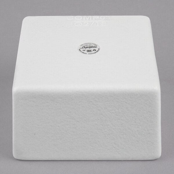 A white cube with a small hole in the middle and a logo for G.E.T. Enterprises.
