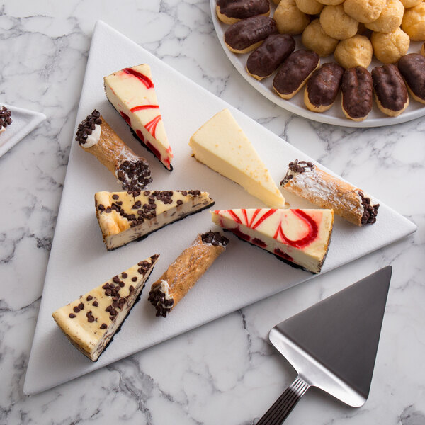A white G.E.T. Enterprises triangle disc with a slice of cheesecake with chocolate chips on top.