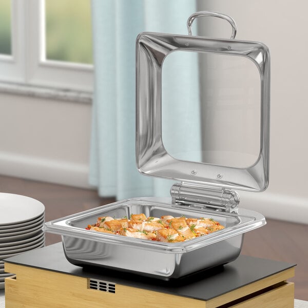 A silver stainless steel Acopa Voyage chafer with food inside.