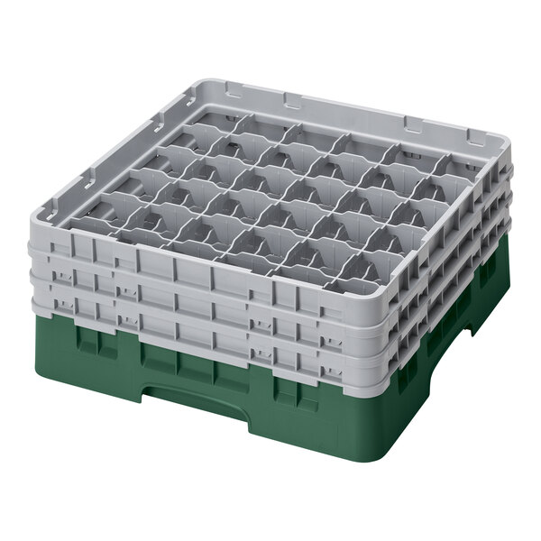 A white plastic Cambro glass rack with six Sherwood green compartments.