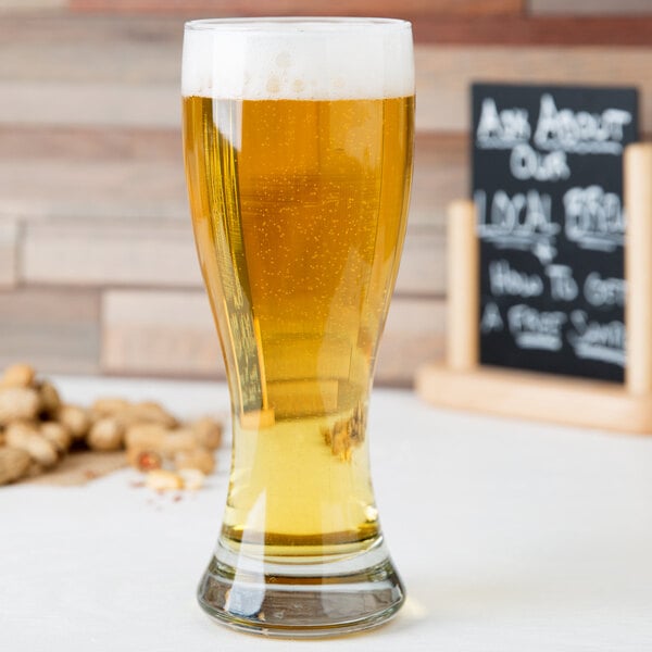 Tall weizen glass filled with light-colored beer