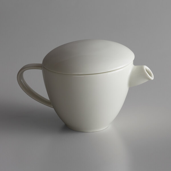 A white Schonwald WellCome teapot with a lid.