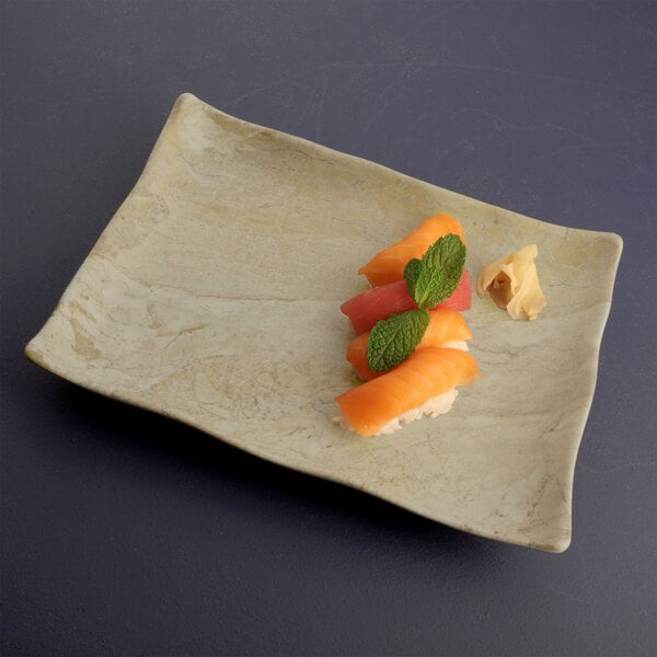 An Elite Global Solutions sandstone rectangular tray with sushi on it.