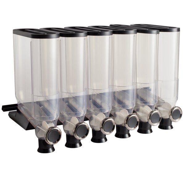 A white shelf holding six clear plastic cereal dispensers with black lids.