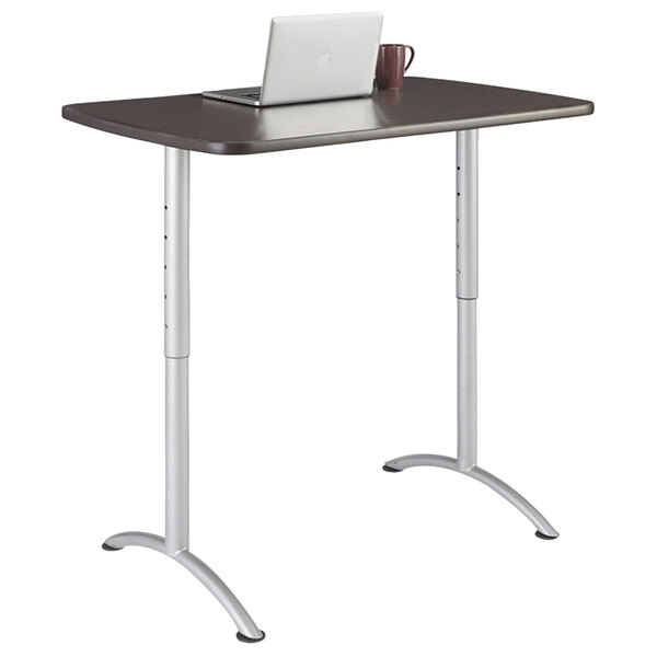 A laptop on a gray rectangular Iceberg sit-to-stand table with silver legs.
