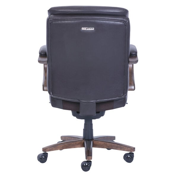 A back view of a La-Z-Boy Woodbury mid-back brown leather executive office chair with a wooden base.