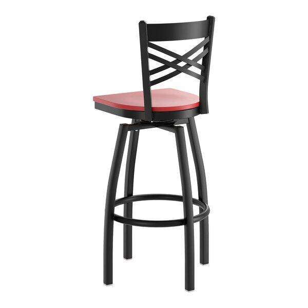 A black metal swivel bar stool with a cross back design and a mahogany wood seat.