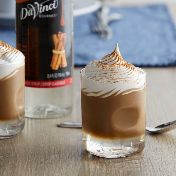 A glass of hot chocolate with DaVinci Classic Cinnamon Syrup and whipped cream.