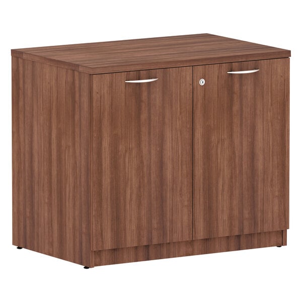 A Alera Valencia Modern Walnut storage cabinet with two doors.