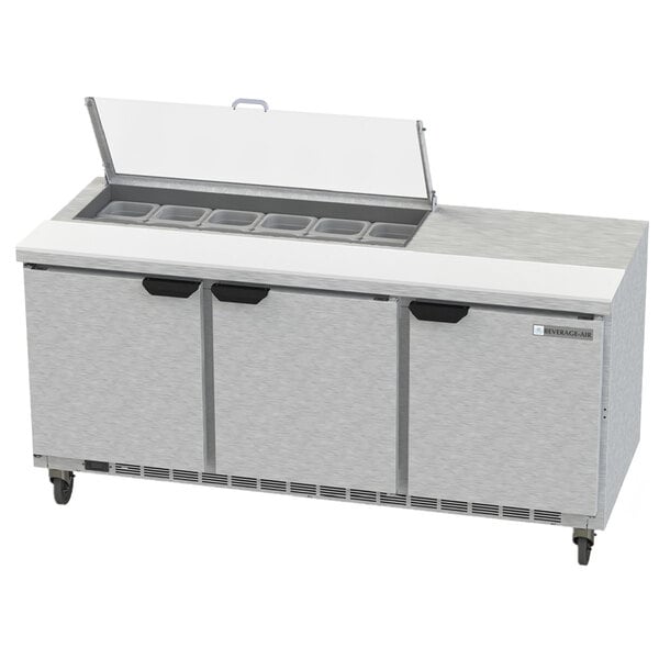 A Beverage-Air stainless steel refrigerated sandwich prep table with three doors and a lid open.