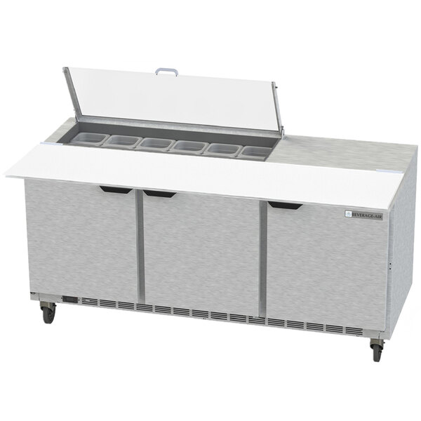 A Beverage-Air stainless steel sandwich prep table with clear lids on a counter.