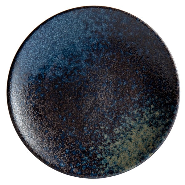A blue and black Playground stoneware plate with a speckled design.