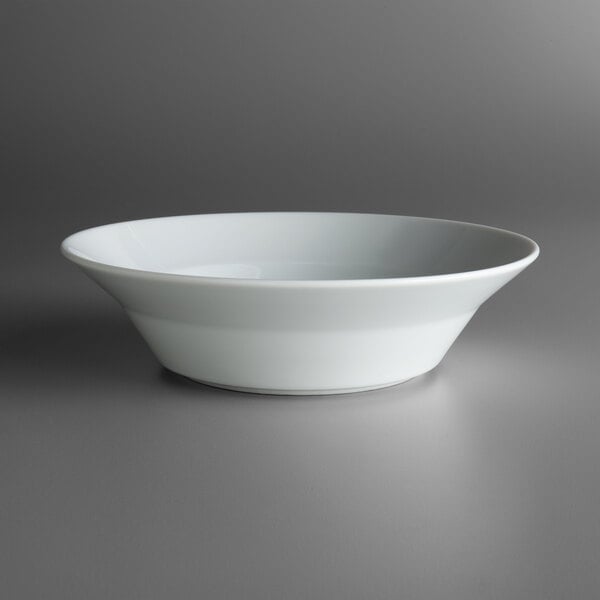 A Schonwald white porcelain round bowl on a gray surface.