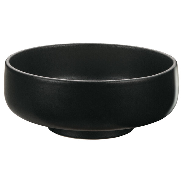 A black Playground Nara stoneware bowl with a handle.