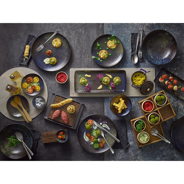 A table with Playground Sea Round Dip Dishes filled with food.