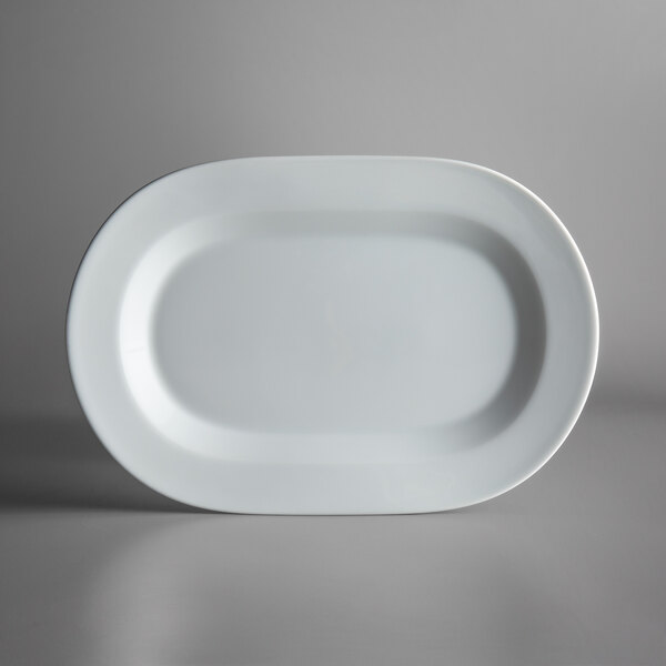 A white oval Schonwald porcelain platter with a black rim on a white surface.