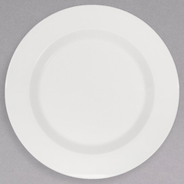 A Schonwald white porcelain plate with a white rim on a gray surface.