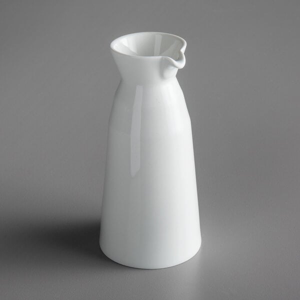 A Schonwald Allure bone white porcelain cruet on a gray surface.