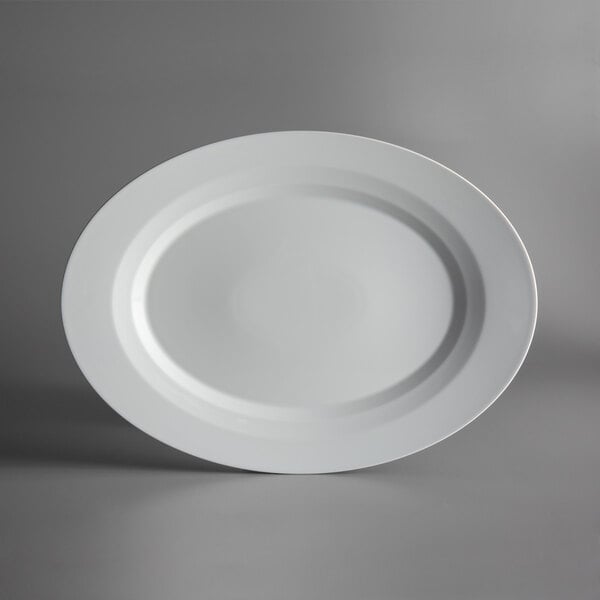 A Schonwald bone white porcelain platter with a raised rim on a gray surface.