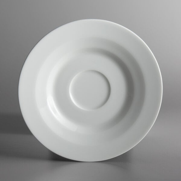 A Schonwald bone white porcelain saucer with a circle in the middle.