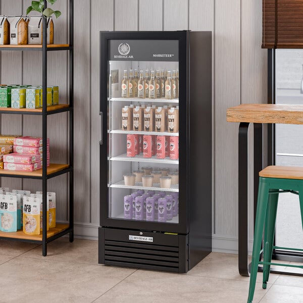 A black refrigerated glass door merchandiser with LED lighting, displaying various beverages and products inside.