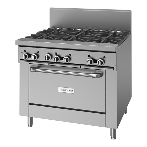 A commercial stainless steel 6-burner range with an oven and control knobs on the front.