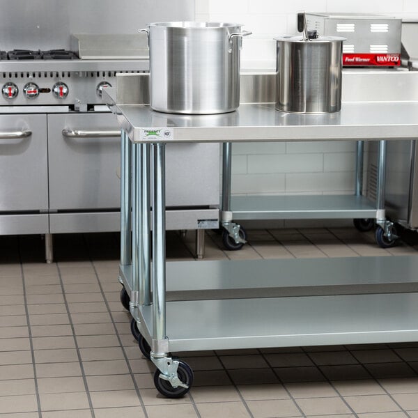 A Regency stainless steel work table with a large pot on top.