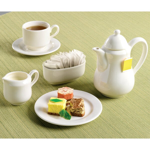 a white teapot with a yellow tea bag