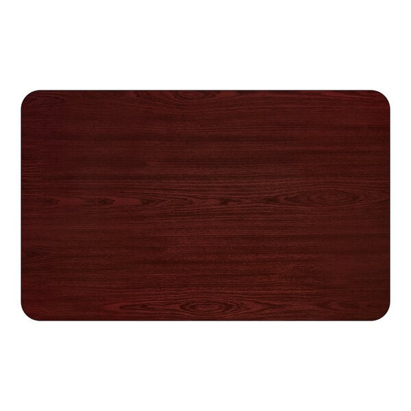 A rectangular dining table with a cherry wood finish and rounded corners.