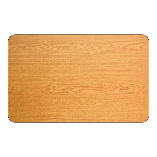 A rectangular, reversible dining table top with a light oak wood finish and rounded corners.