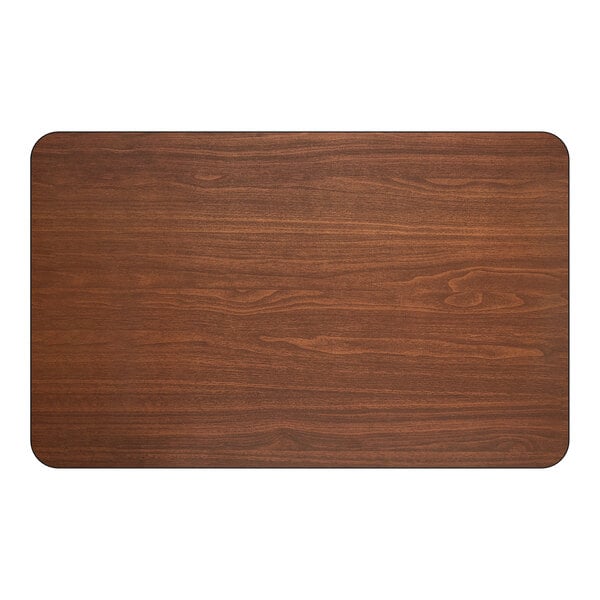 A rectangular, reversible dining table top with a walnut wood finish and rounded corners.