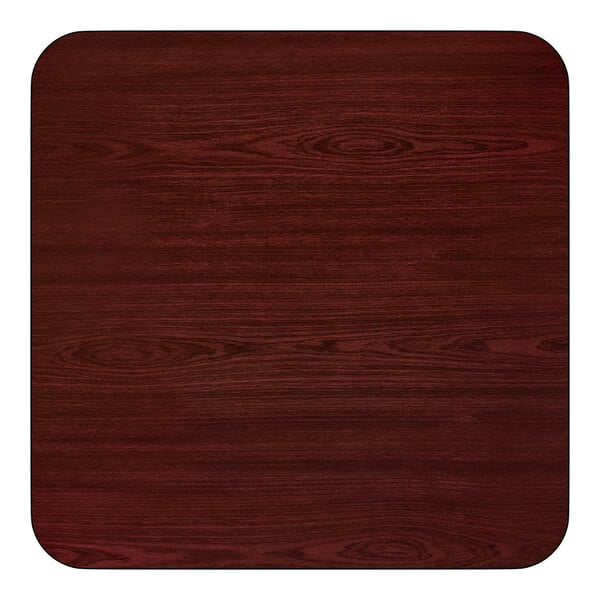A square, reversible dining table top with a cherry wood finish and rounded corners.