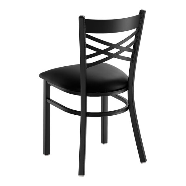 A black cross back dining chair with a padded seat and metal frame.