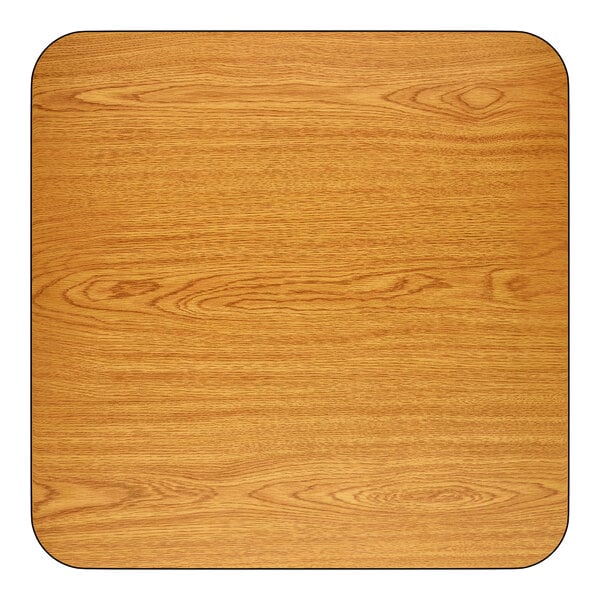A square, light oak-colored tabletop with rounded corners and a wood grain finish.