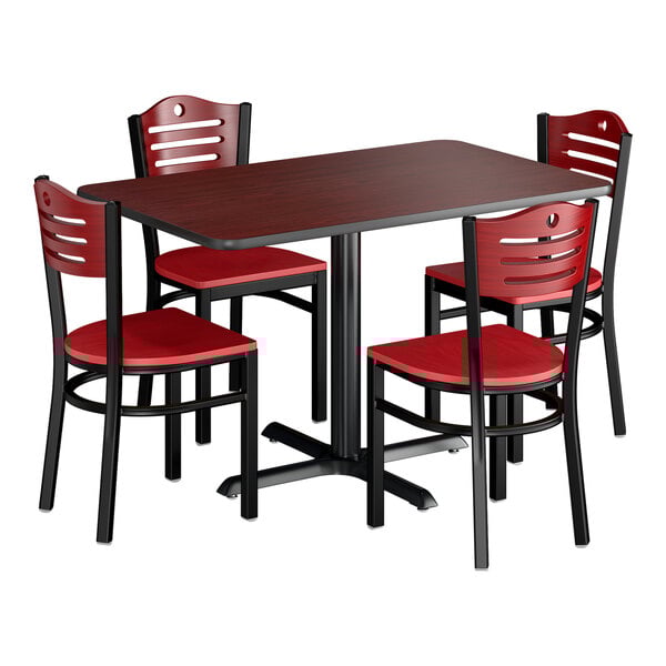 A rectangular dining set with a dark wood table and four matching chairs featuring red seats and backs.