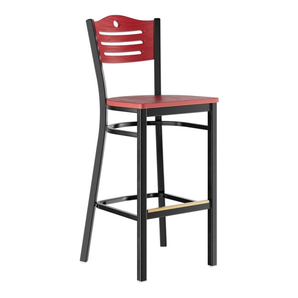 A bar stool with a mahogany wood seat and backrest, featuring a black metal frame and footrest.