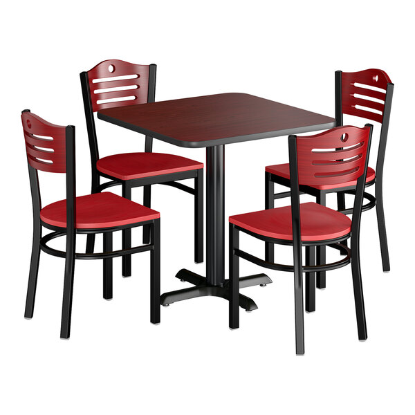 A square dining set with a dark wood table and four matching chairs featuring red wooden seats and backs with black frames.